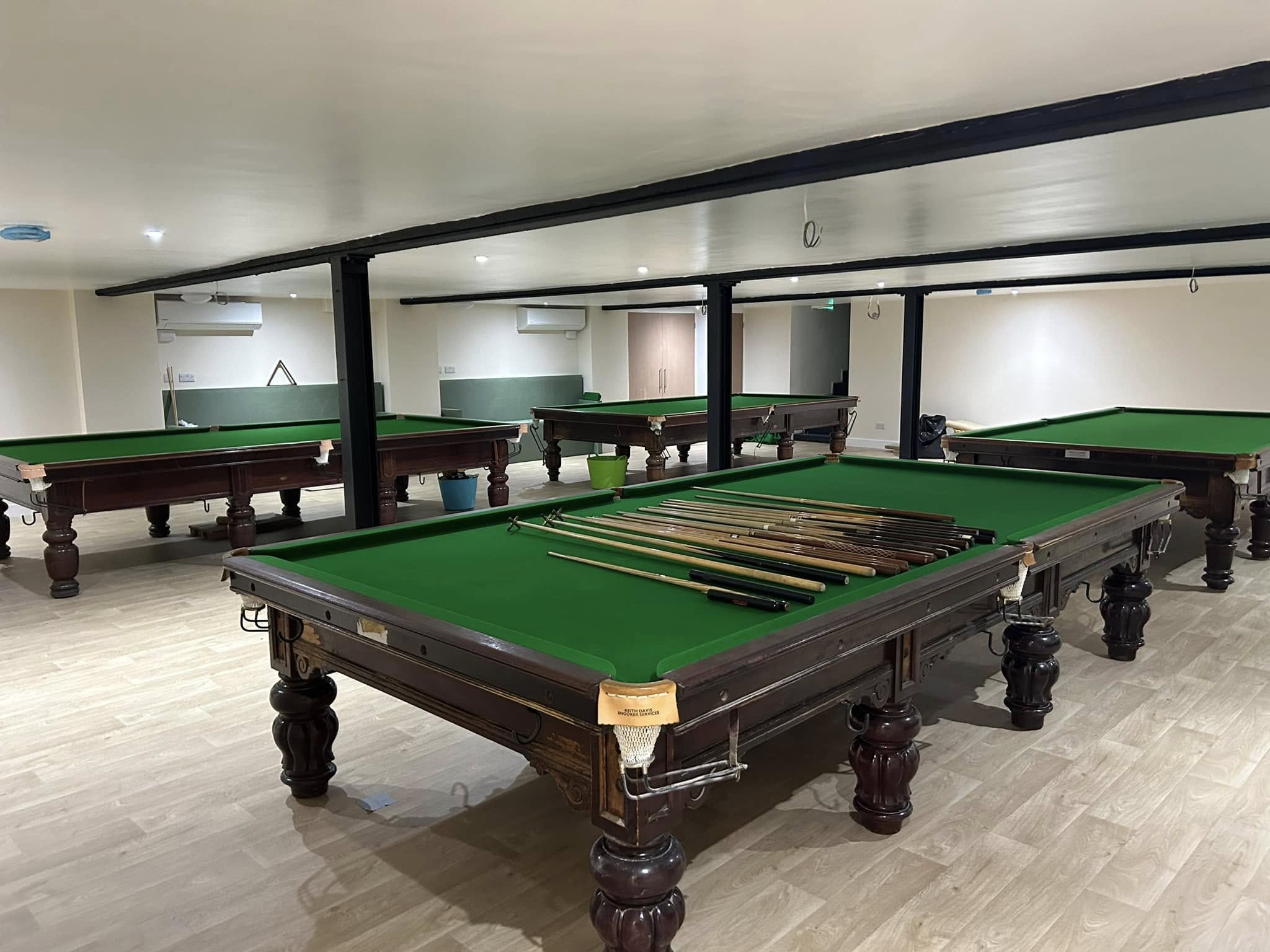 Snooker tables and cues inside George Street Snooker Club in Colchester.
